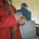 Participant dégustant un verre de vin blanc et un canelé lors d'une croisière gourmande à Bordeaux.